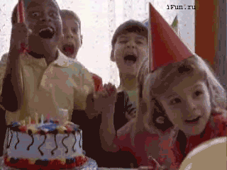 Kids celebrating a birthday with cake and candles