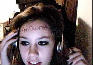 Webcam selfie girl with headphones, forehead text