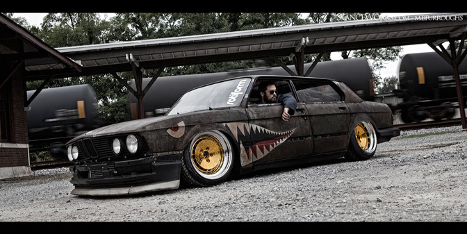 Slammed shark-mouth BMW rolling low at the trainyard