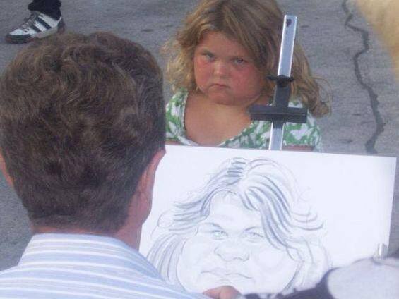 Grumpy kid's caricature portrait mid-sketch, street artist scene