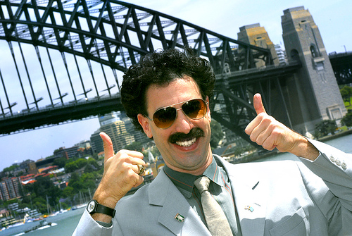 Borat thumbs-up in front of Sydney Harbour Bridge