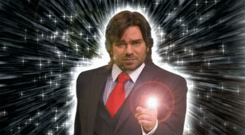 Guy in suit summons a glowing sparkle effect