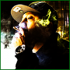 Member avatar smoking, moody green-lit shot